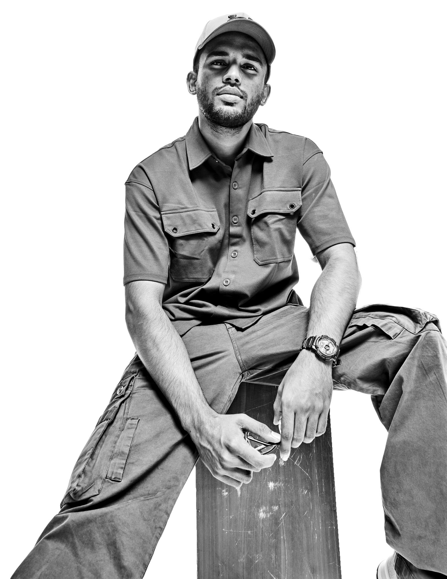 Basith, seated, photographed in black and white against white